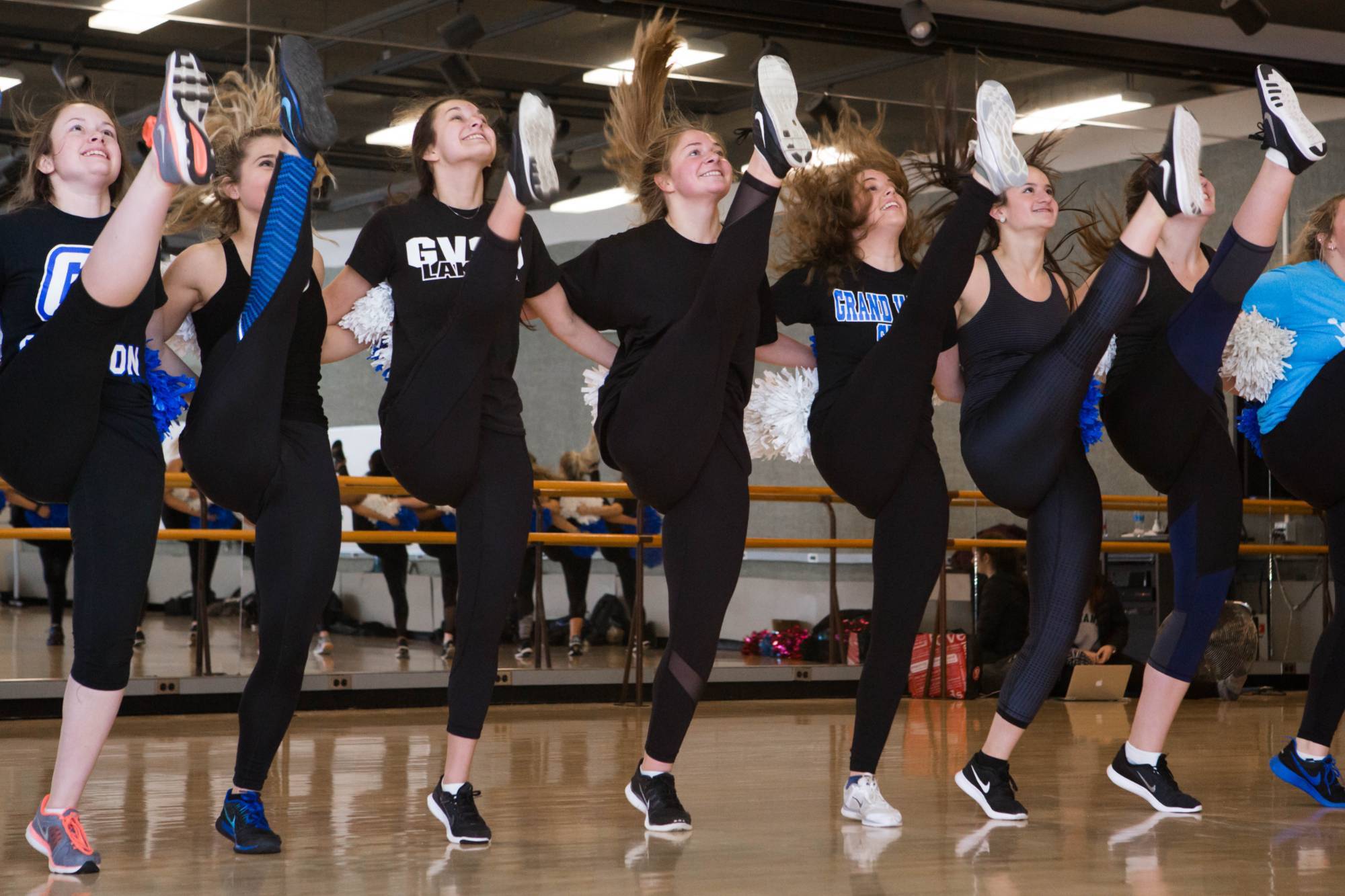 students in a line kicking their legs